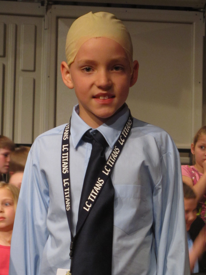 Harry during an elementary school play as a bald principal